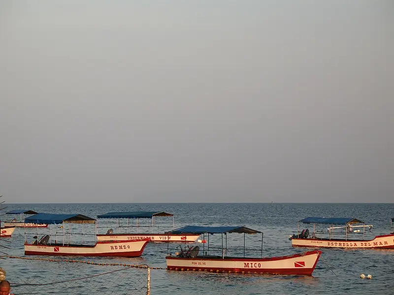 Dive boats lined up on the shore at Anilao, Mabini