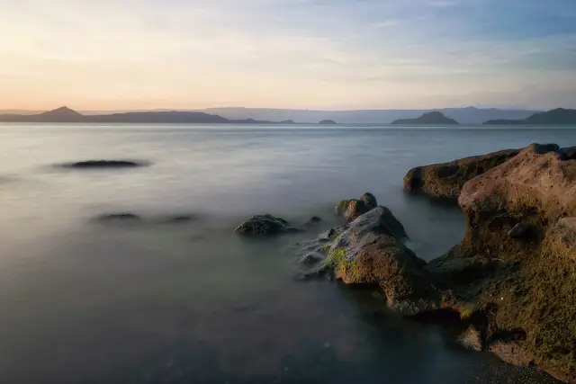 Taal Volcano Island and Taal Lake at sunset, seen from the Batangas shore