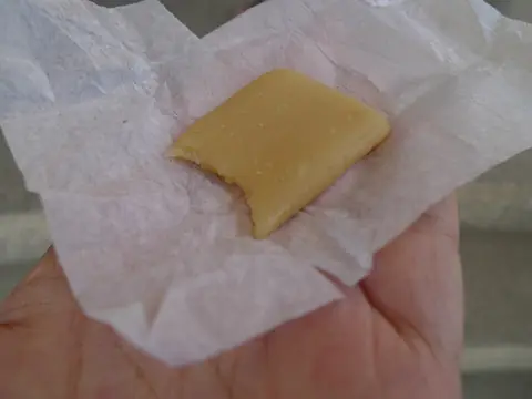 An unwrapped piece of pastillas de leche milk candy (photographed in Cagayan)