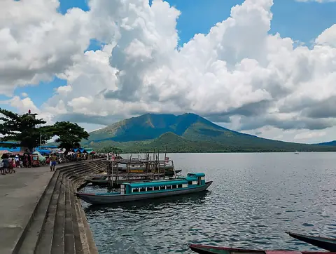 Boats moored on Lake Buhi below Mount Asog