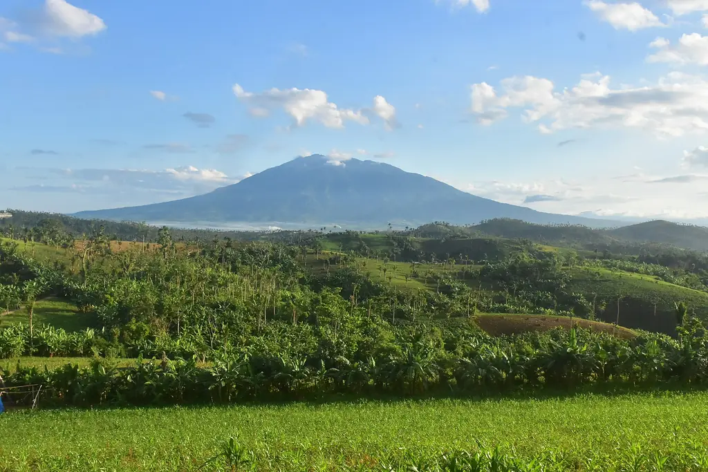 Mount Isarog above green fields, seen from Baao