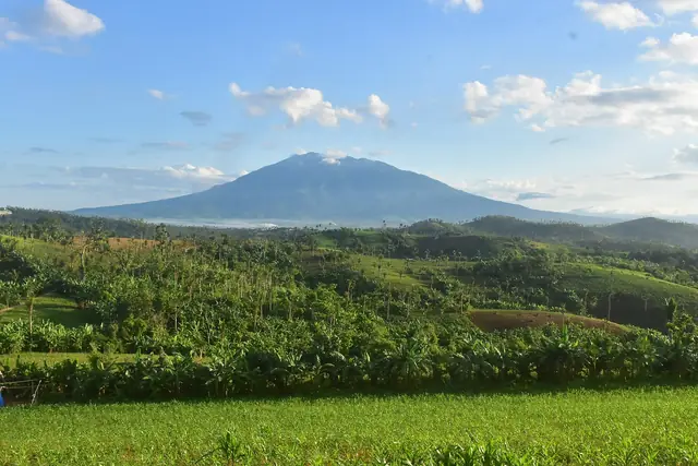 Mount Isarog above green fields, seen from Baao