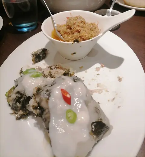 Pinangat: taro-leaf parcels cooked in coconut milk, served with shrimp paste