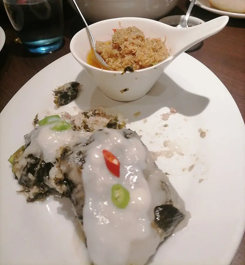 Pinangat: taro-leaf parcels cooked in coconut milk, served with shrimp paste