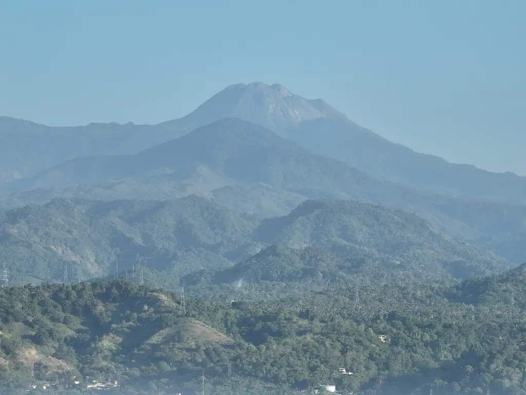 Mount Apo rising above forested ridges, seen from Digos City