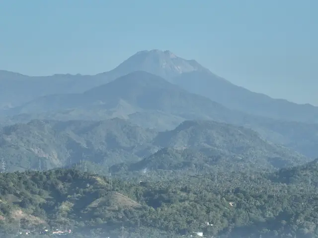Mount Apo rising above forested ridges, seen from Digos City