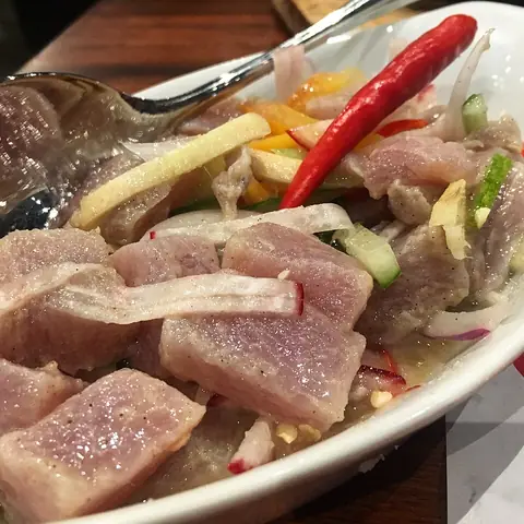 Kinilaw: raw fish cubes in vinegar with onion and red chili