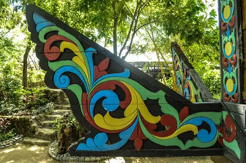 A carved and painted panolong, the okir-decorated beam end of a torogan