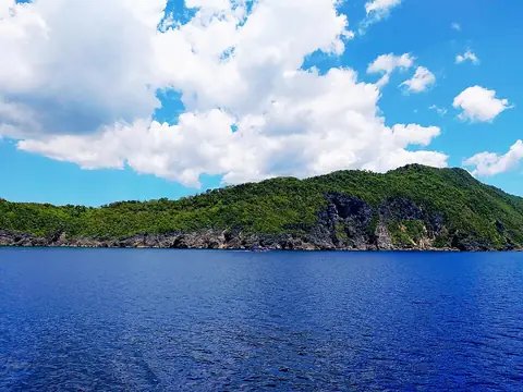 The green coast of Ticao Island above deep-blue water