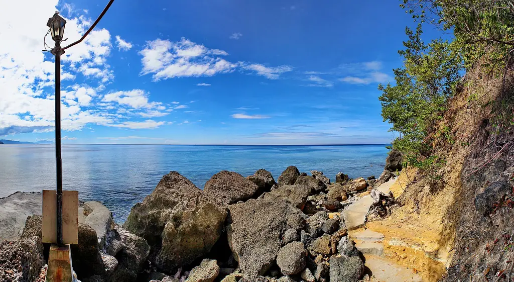 Rocky shore and blue water of Sarangani Bay Protected Seascape