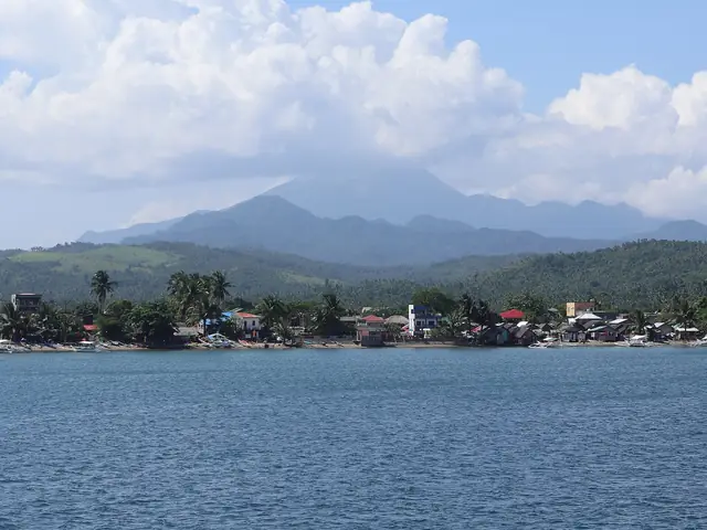 Mount Bulusan rising behind the coast at Matnog, seen from the San Bernardino Strait