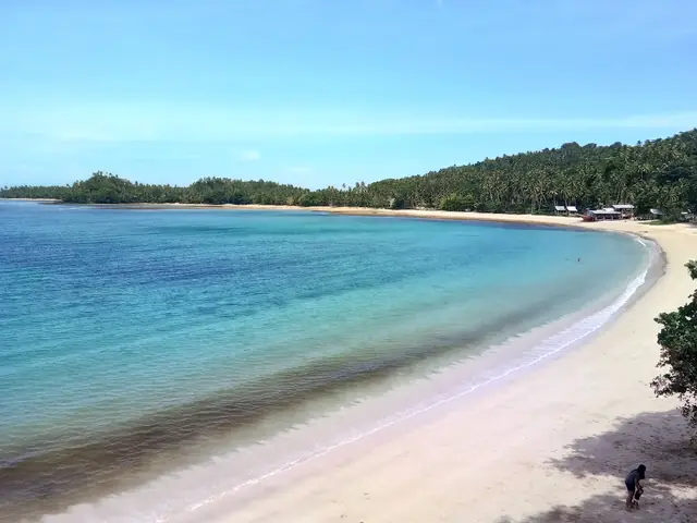 The curving white beach of Cagwait, Surigao del Sur