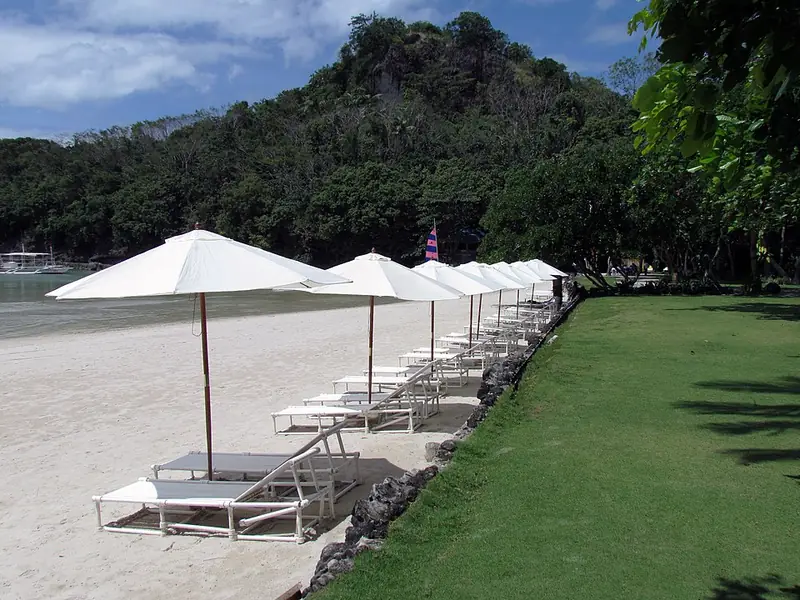 Beach umbrellas and lawn at Dakak Beach Resort